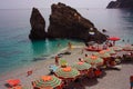 Rows of sun umbrellas from the sea with horizontal colored stripes in order on the beach in front of the Ligurian sea of Ã¢â¬â¹Ã¢â¬â¹the